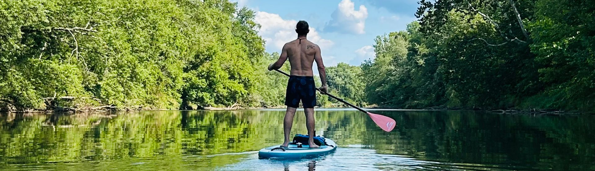Clint Serafino paddleboarding outdoors